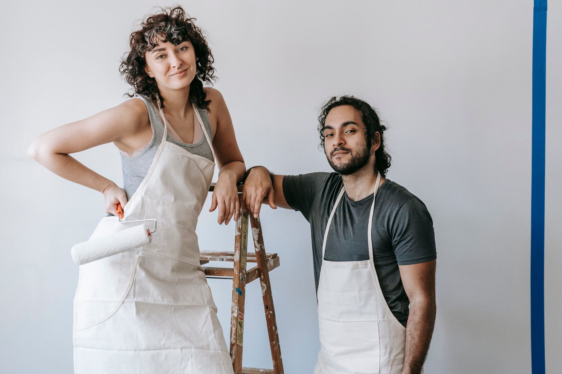 A couple painting their home's interior during a DIY renovation project in Long Beach, CA