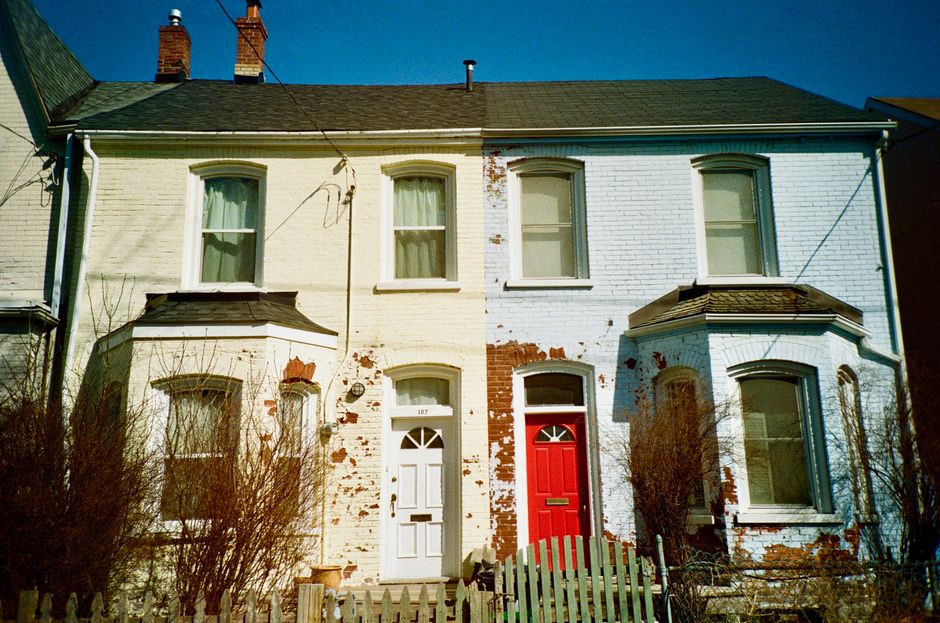 Brick houses with red and white painted doors in a row.